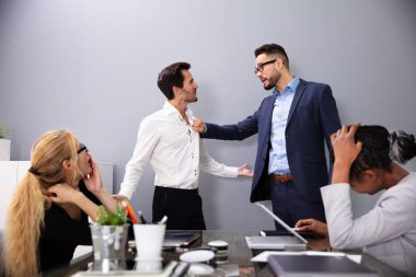 Ceo, genç erkek işçisine iş arkadaşlarının önünde kötü performans sergilediği için bağırıyor.