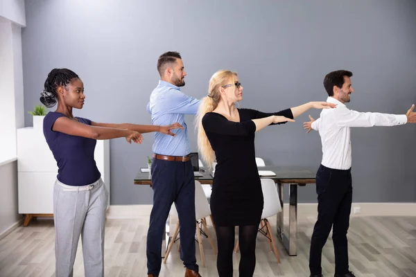 Happy Businesspeople Standing Row Doing Exercise Hands Outstretched Office — Stock Photo, Image