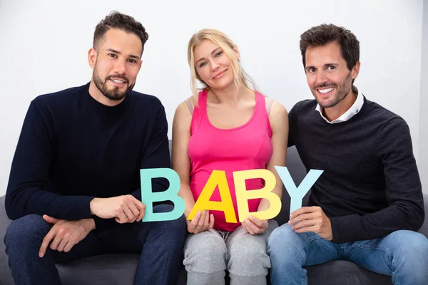 Smiling Men Touching Belly Pregnant Surrogate Woman Holding Baby Word — 스톡 사진