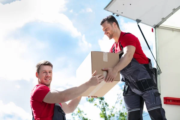 Male Movers Unloading Passing Cardboard Box His Assistant Moving Van — Stok Foto