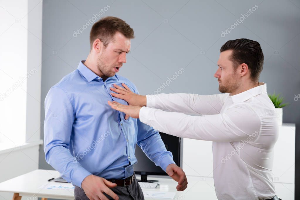 Two Angry Young Businessmen Quarreling With Each Other Fighting In The Office