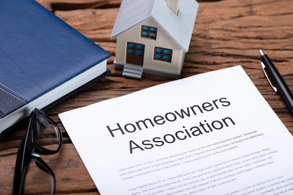 House Model Near HOA Rules And Regulations Document