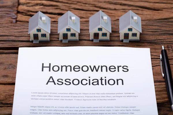 House Model Near HOA Rules And Regulations Document