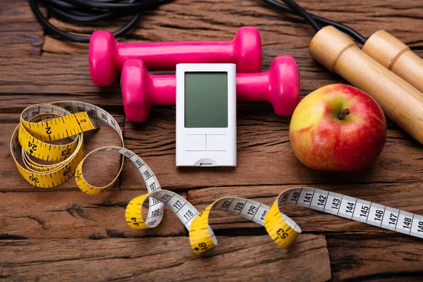 Blackboard with Diabetes Word Near Sports Equipment And Glucometer. Diabetes And Exercise Concept