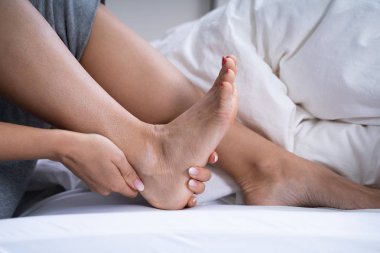 Woman Feeling Achilles Heel Pain In Bed clipart