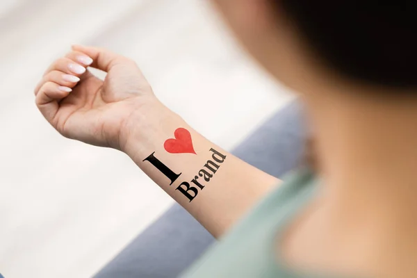 Woman Showing Her Love Brand Tattoo — Stock Photo, Image