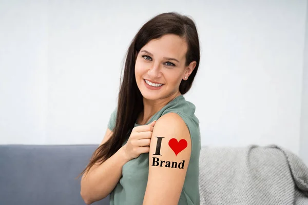 Woman Showing Her Love Brand Tattoo — Stock Photo, Image