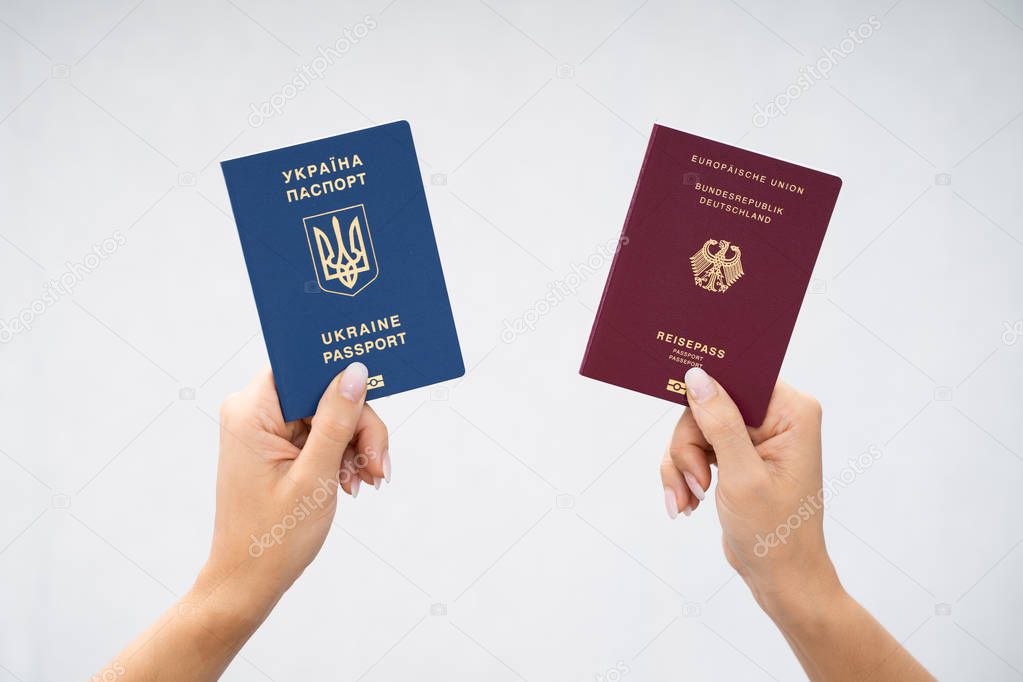 Woman Holding Two Passports. Ukrainian And German
