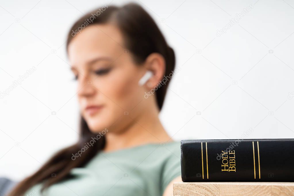 Woman Listening To Bible Audiobook On Smartphone