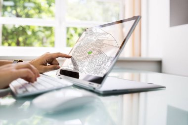 Female Executive Looking At Cadastre Map On Screen clipart