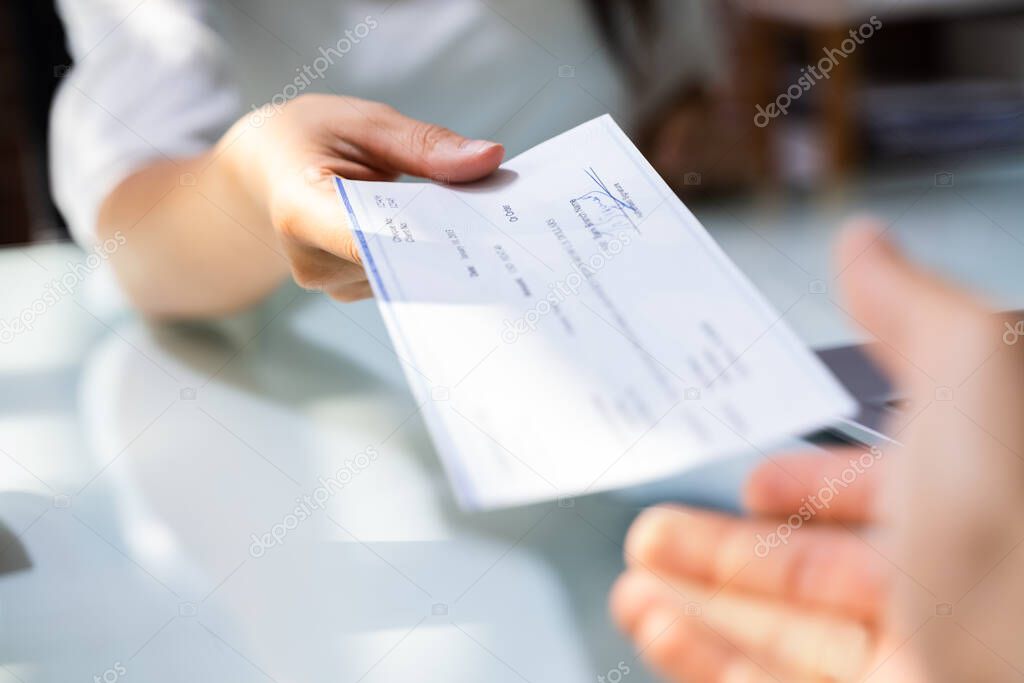 Hand Giving Payroll Compensation Paycheck. Salary Cheque