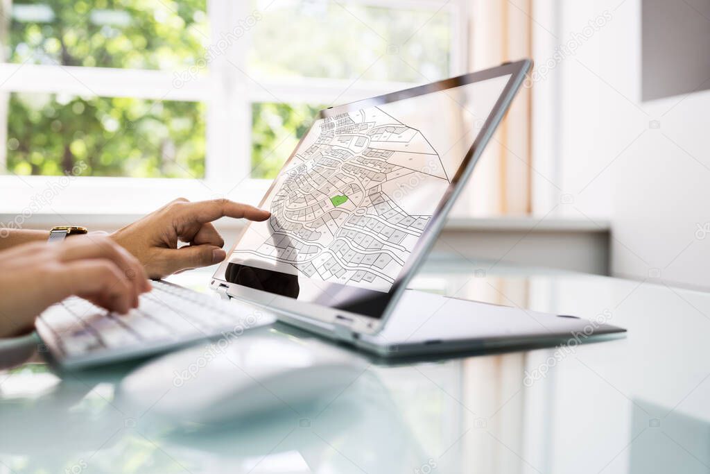 Female Executive Looking At Cadastre Map On Screen