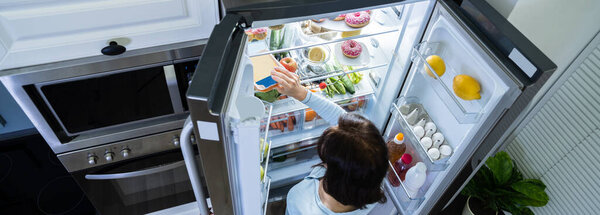 Hungry Woman At Night With Open Fridge