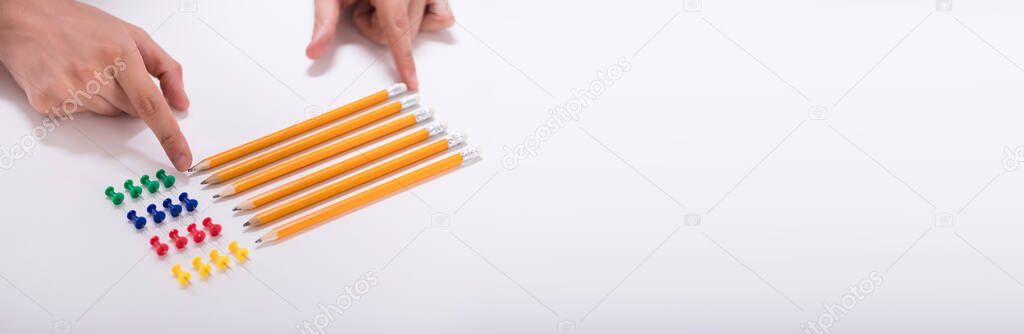 Compulsive Perfectionist Hand Arranging Pencils. OCD Person