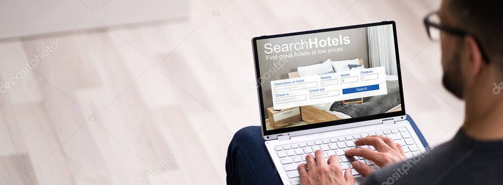 Man Booking Hotel On Website Using Laptop Computer Close Up
