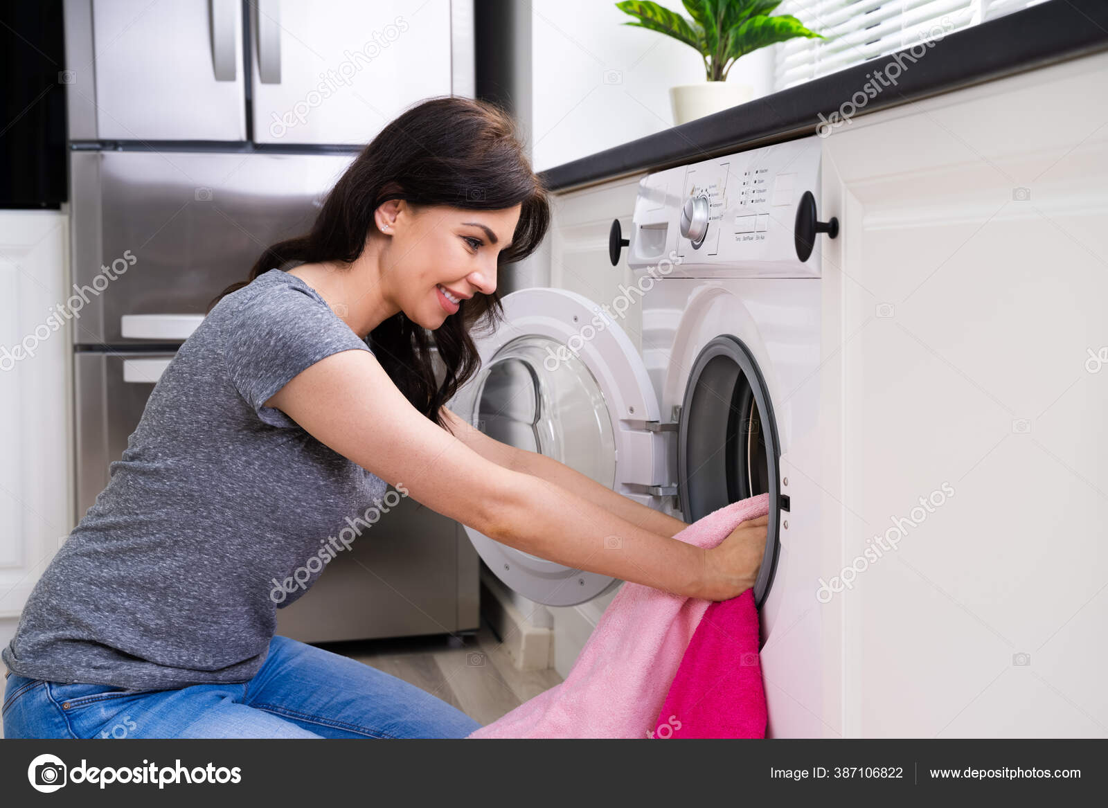 Woman Using Washing Machine Cleaning Clothes Kitchen Stock Photo by  ©AndreyPopov 387106822