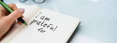 Gratitude Journal Concept. Writing I Am Grateful In Journal clipart