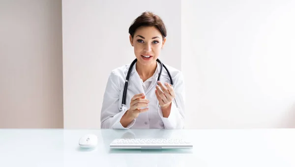 Female Doctor Consulting Patient In Video Conference