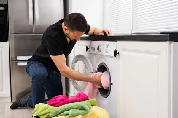 Man Loading Clothes Washing Machine Kitchen — Stock Photo, Image
