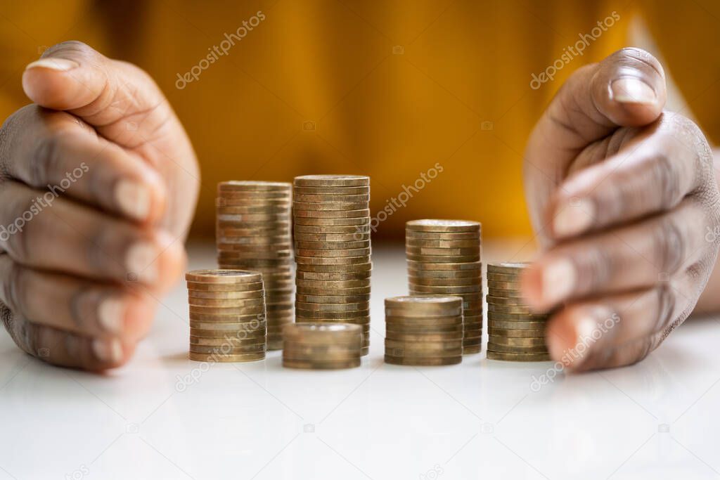 African Woman Protecting And Securing Money On Desk
