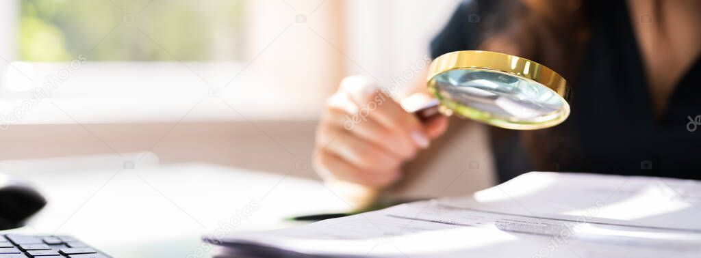 Auditor Investigating Corporate Fraud Using Magnifying Glass