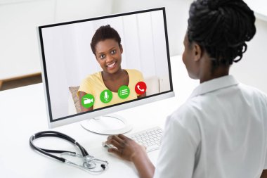 Video konferansında Afrikalı doktor hastayla konuşuyor.
