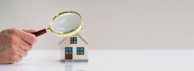Home Inspection And House Appraisal Using Magnifying Glass clipart