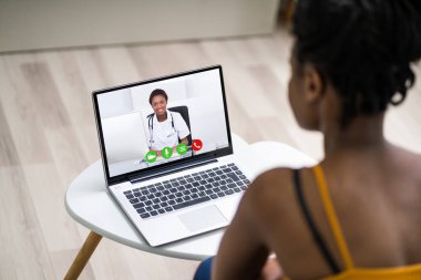 Online Videoconference On Laptop With African Doctor clipart