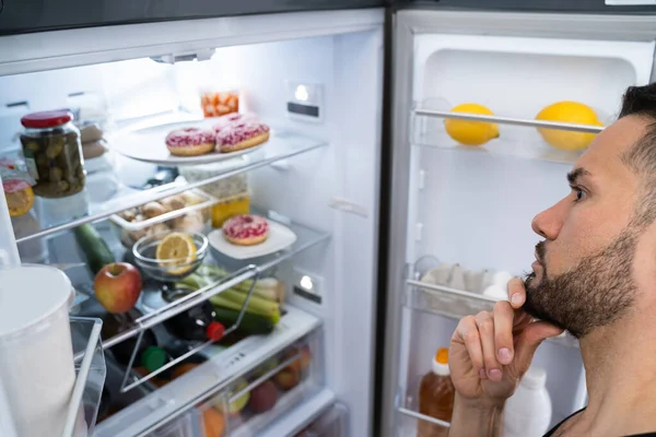 Hungry Confused Man Looking Open Fridge Kitchen — Stock Photo, Image