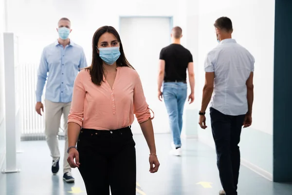 People In Office Following Social Distancing Protocols Wearing Face Masks