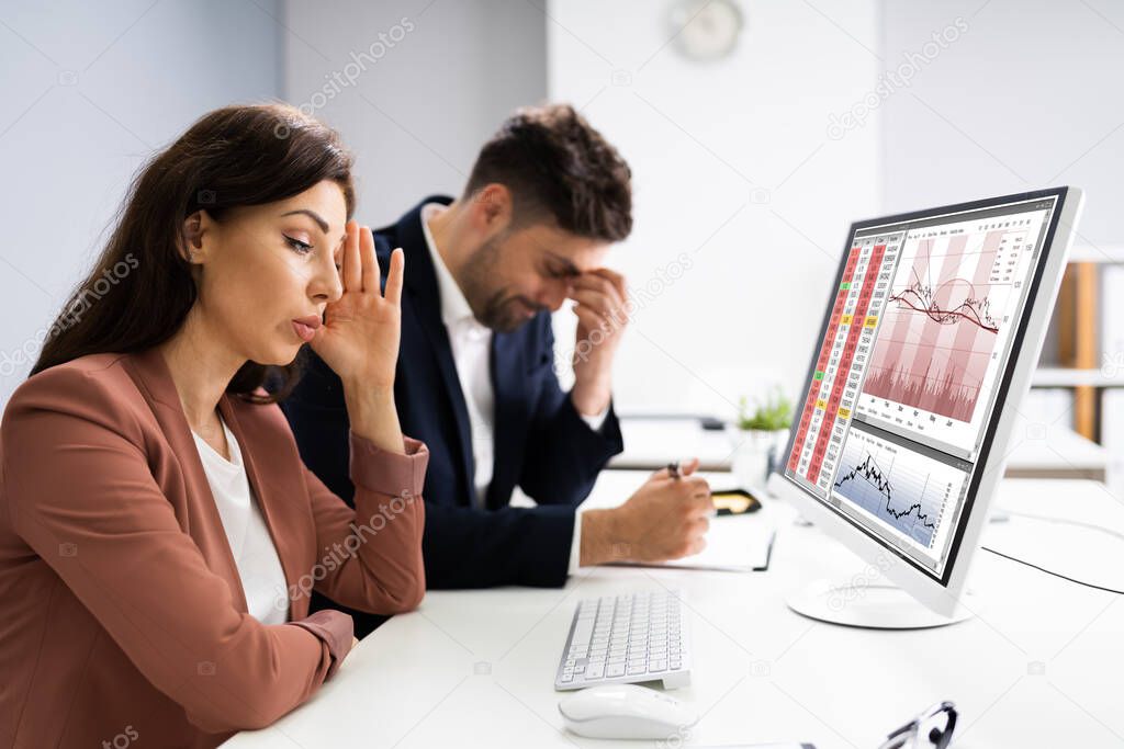 Businessman Looking At Audit Data And Financial Loss. Stock Down