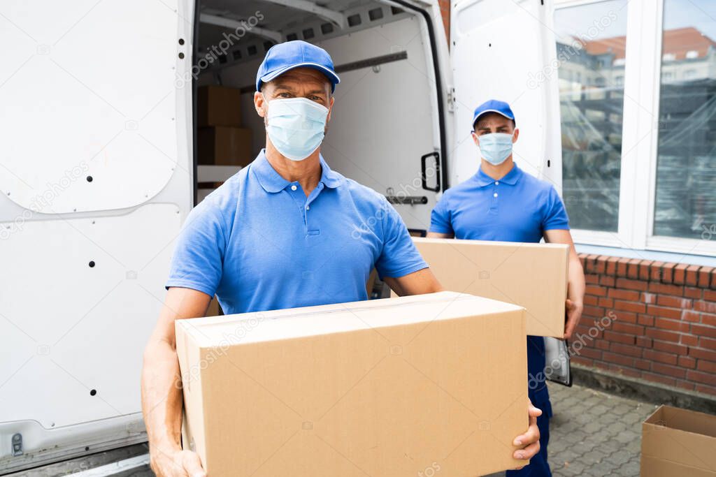 Blue Delivery Men Unloading Package From Truck With Face Mask