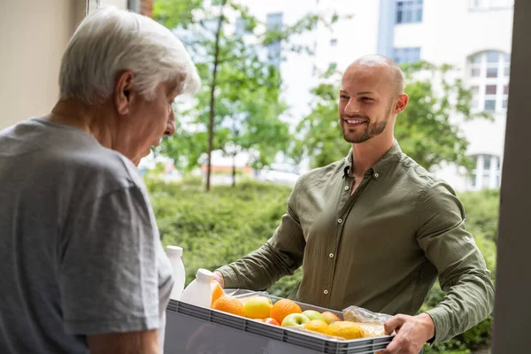 Grocery Food Shopping Help For Elder Senior Standing At Door