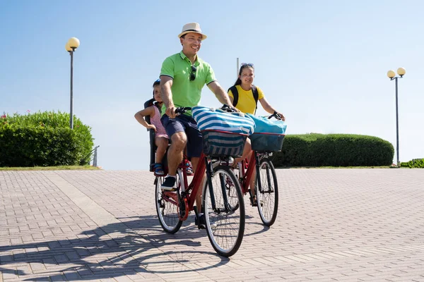 Family Riding Bicycle Outside. Happy People Doing Sports