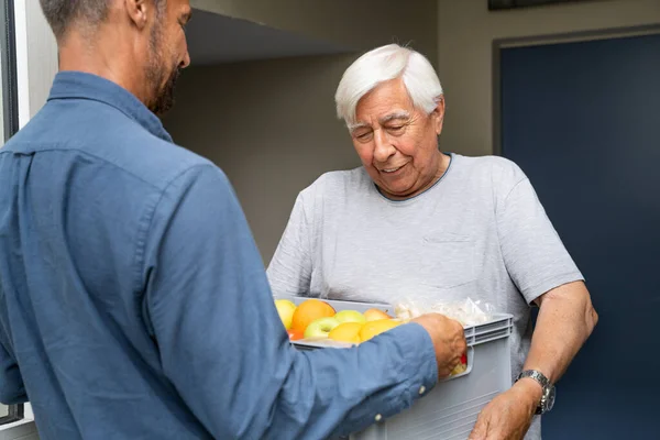 Grocery Food Shopping Help For Elder Senior Standing At Door