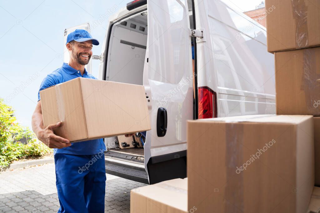 Truck Mover Unloading Van Carrying Boxes And Moving House