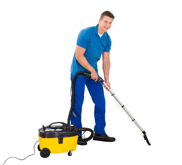 Young Man Cleaning Floor Using Vacuum Cleaner White Background — Stock Photo, Image