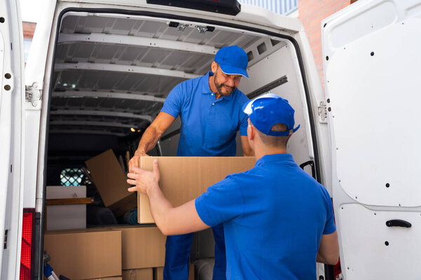 Home Moving Services. Movers Loading Van Or Truck