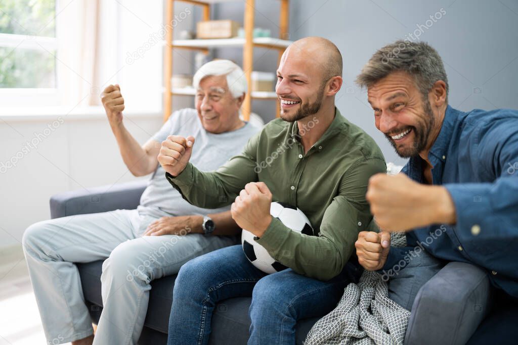 Three Generation Sport Fans Watching Football On TV