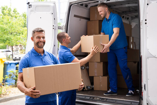 Truck Movers Loading Van Carrying Boxes And Moving House