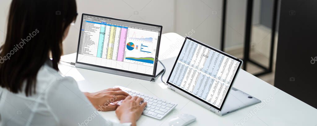 Analyst Employee Working With Spreadsheet Report On Screen