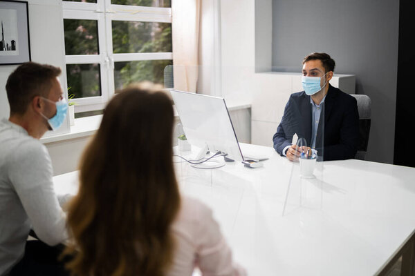 Young Family Couple Meeting Consultant Or Lawyer With Face Masks