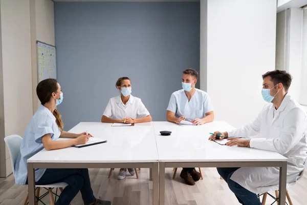 Medical Doctor Students At Desk Learning With Face Masks