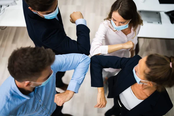 Employees Doing Elbow Bump To Avoid Flu And Stop Covid Spread