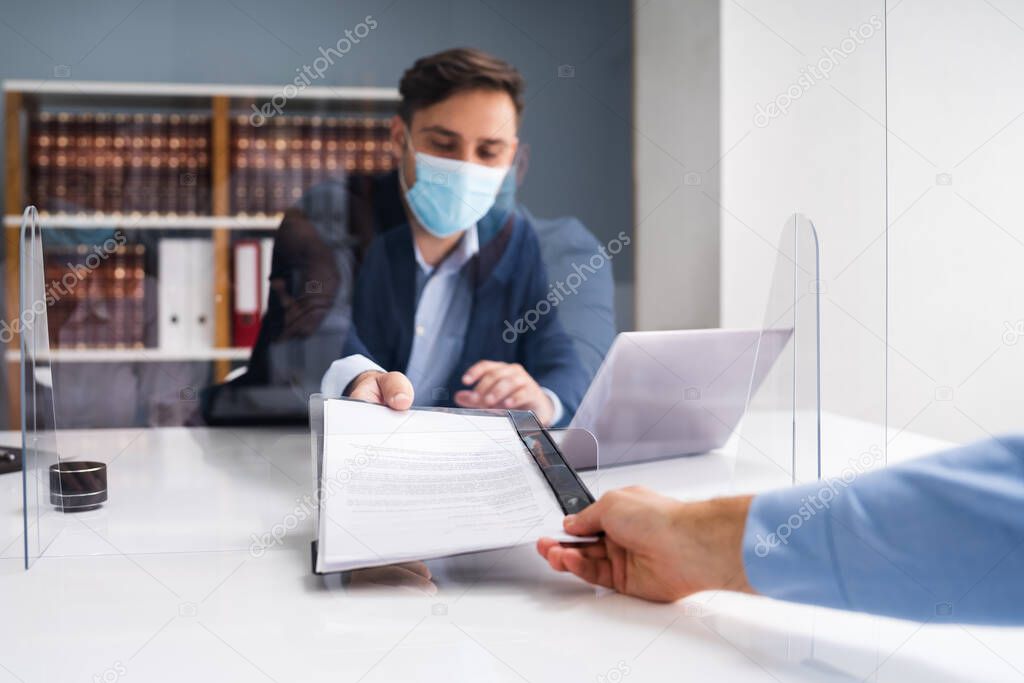 Consultant Giving Contract Papers Through Sneeze Guard