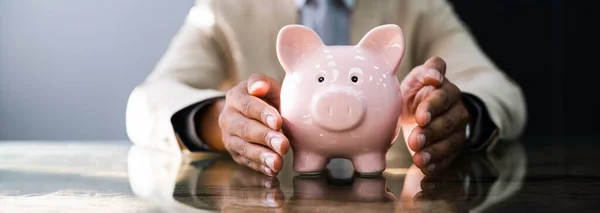 African American Male Protecting Piggy Bank Inglés Seguro Presupuestario — Foto de Stock