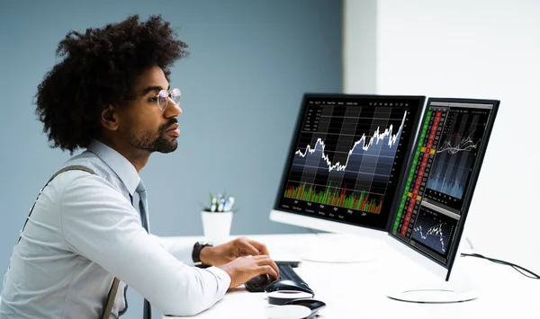 Stock Exchange Analyst Using Multiple Computer Screens