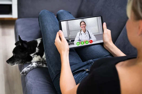 Web Video Conference Call With Doctor On Tablet Computer