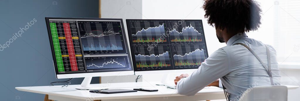 African American Man Trading Stock Market Online On Computer