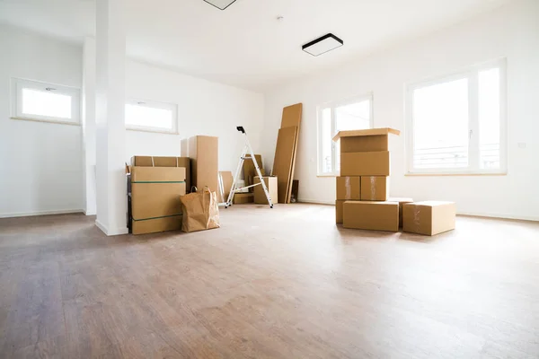 Empty Room With Moving Boxes Or Cartons